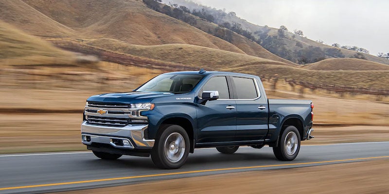 Image of Silver 2022 Chevrolet Silverado driving on the road