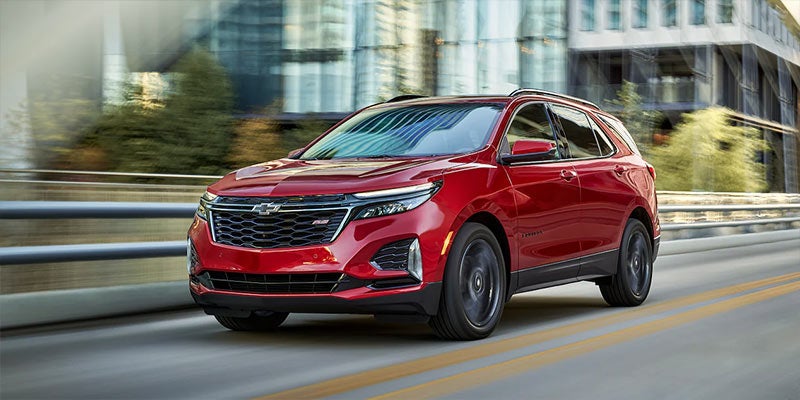 Image of red 2022 Chevrolet Equinox driving on the road