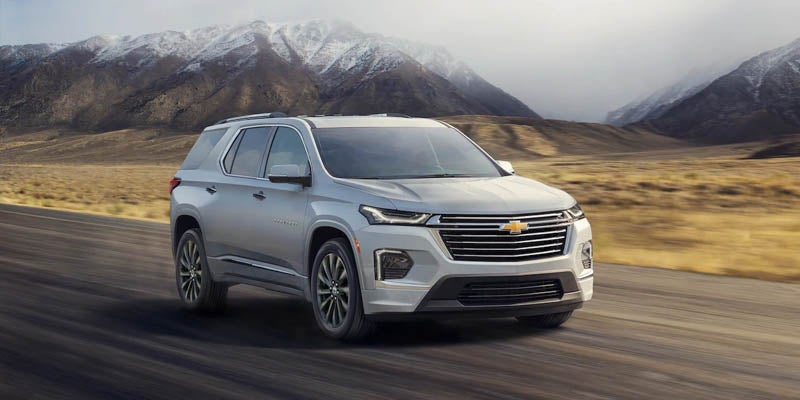 Image of silver 2022 Chevrolet Traverse driving on the road