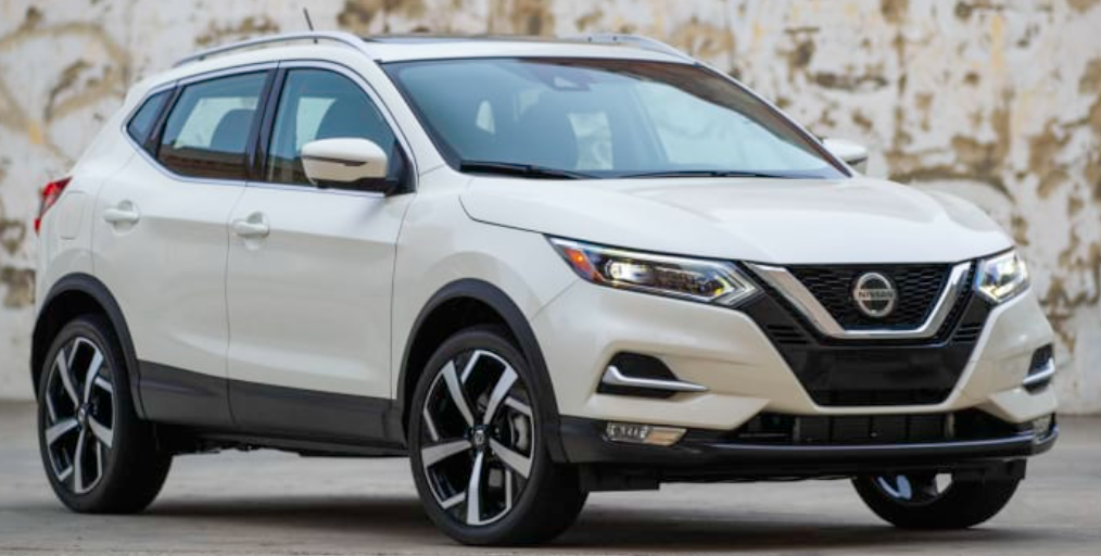 Image of a white 2022 Nissan Rogue parked beside a wall