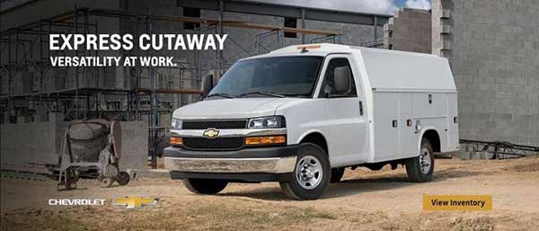 A white commercial van at a construction site